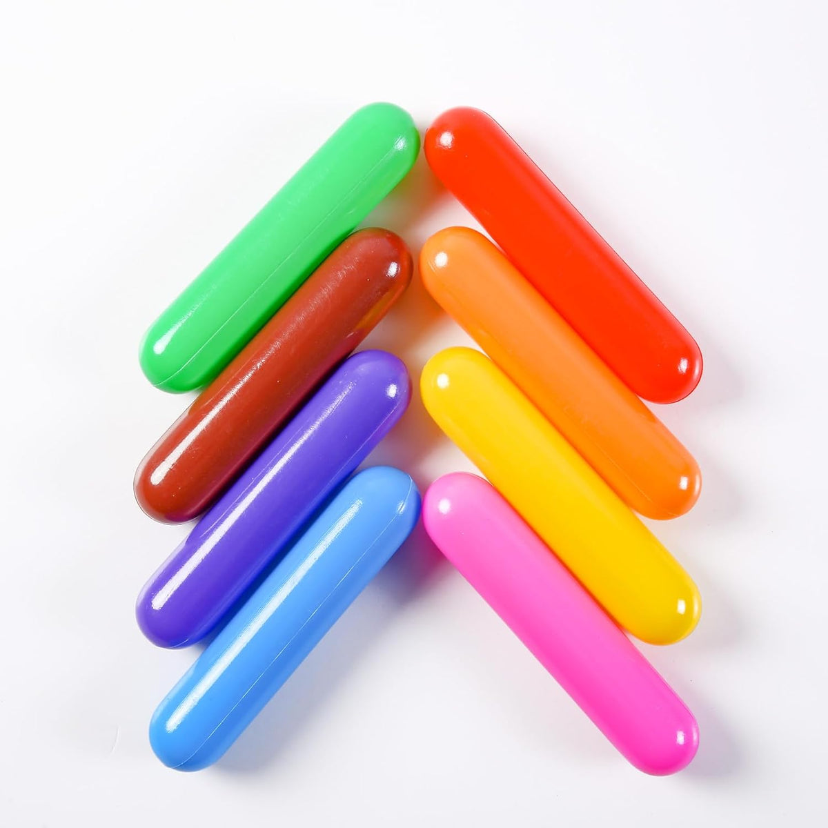 Assorted multicolour cylinder-shaped plastic play balls arranged on a white background.