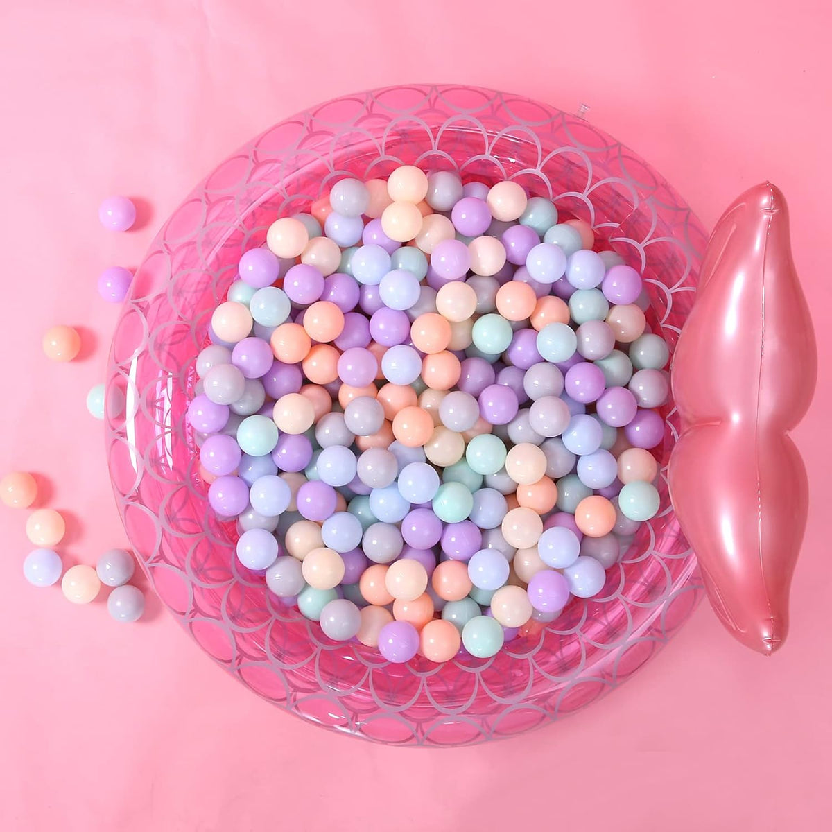 Pastel ball pit balls in a pink inflatable pool