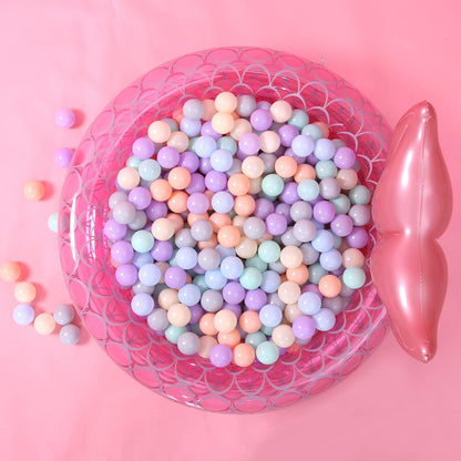 Pastel ball pit balls in a pink inflatable pool