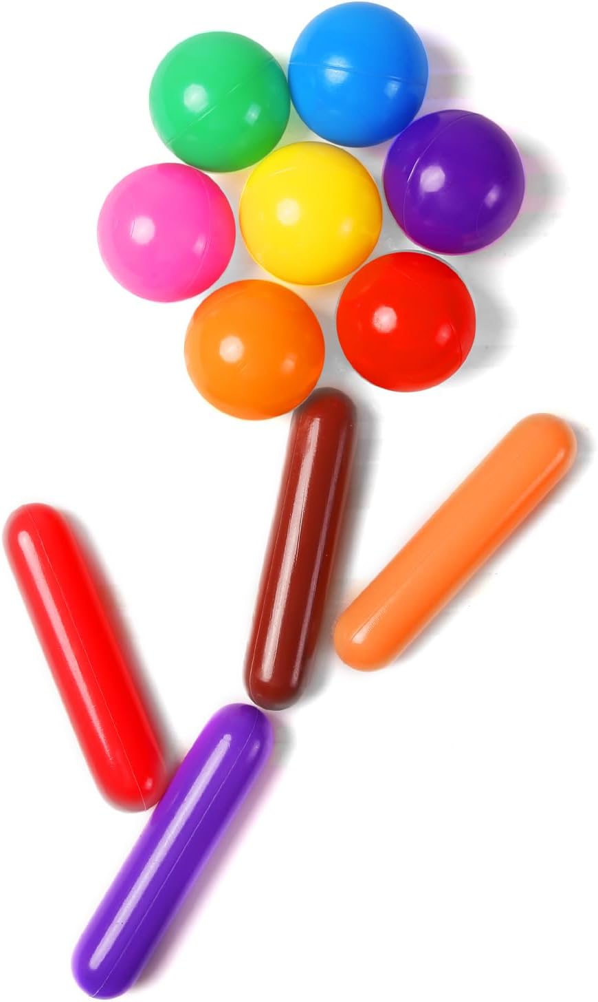 Multicolour cylinder pieces and round ball pit balls arranged on a white background
